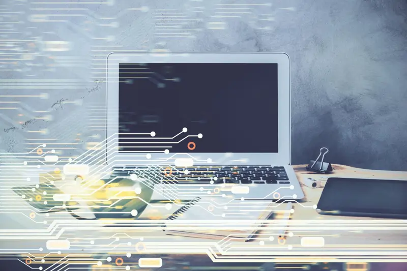 Image of an open laptop with computer technology graphics across the image. Elevated Networks provides technological support for personal and business computers.