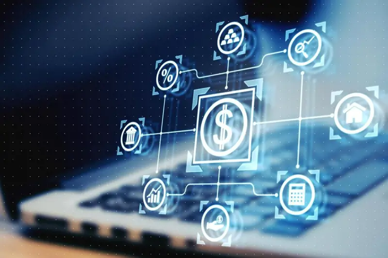 An icon with a dollar sign in the center and other symbols around the dollar sign sits on top of an image of an open laptop computer. The services of Elevated Networks can result in cost savings.